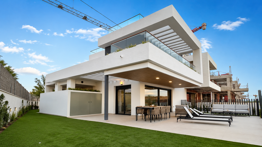 Terrace of a new house with a construction site and crane in the background